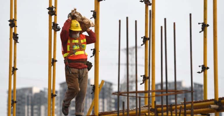 Nanning, China's Guangxi Zhuang Autonomous Region. 21st Feb, 2020. A laborer works at a construction site in Nanning, capital of south China's Guangxi Zhuang Autonomous Region, Feb. 21, 2020. Construction industry has gradually resumed amid strict prevent